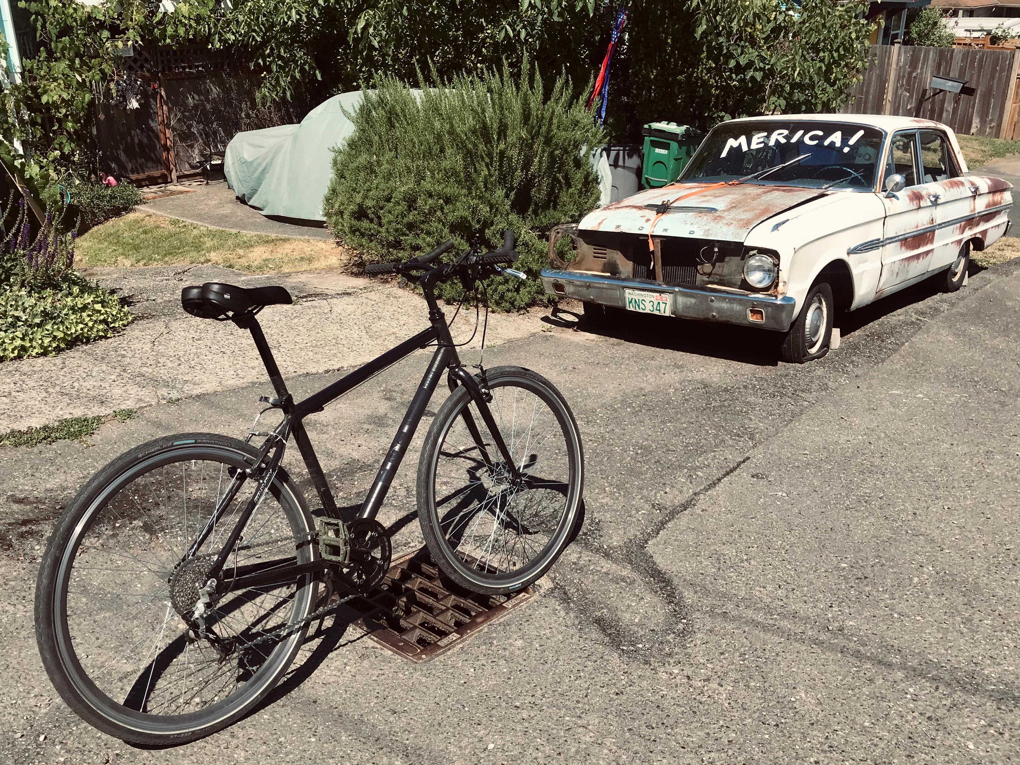 image of bicycle next to car with Merica painted on it